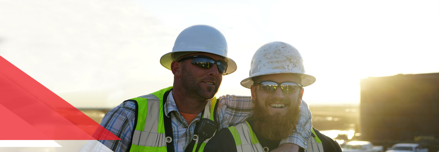 Header image of two employees sharing a laugh